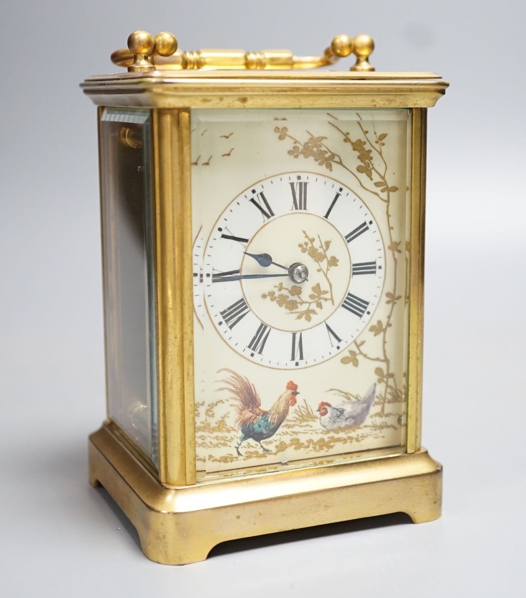 A late 19th century French brass carriage timepiece, the dial enamelled with chickens and foliage. 13.5cm (handle down)